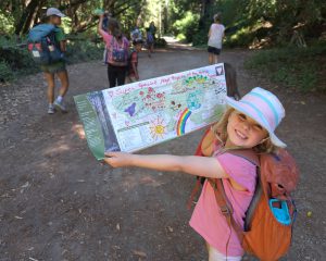 IBL-Call-of-the-Wild-Camps-outdoor-nature-camp-smiling-girl-hiker-with-treasure-map-1.54-mb-1